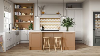 Beige ribbed kitchen cabinets with white marble backsplash and peach walls.